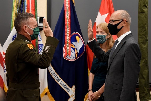 Lt. Gen. Daniel Karbler, commanding general, U.S. Army Space and Missile Defense Command, issues the oath of office to Dr. Neset Akӧzbek, senior research scientist in SMDC's Technical Center, during his senior scientific professional appointment ceremony at the command's Redstone Arsenal, Alabama, headquarters, Oct. 19. (U.S. Army photo by Carrie David Campbell)