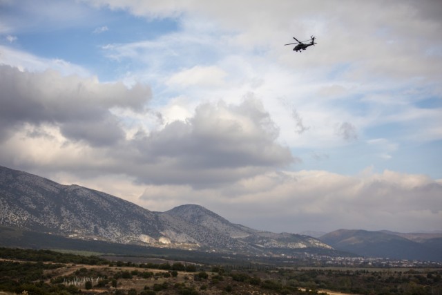 A Hellenic Army AH-64 Apache attack helicopter advances on target during the combined arms live-fire exercise for Olympic Cooperation 2021 at Petrochori Range, Triantafyllides Camp, Greece, Nov. 16, 2021. Olympic Cooperation 2021 is a live-fire and maneuver exercise designed to enhance interoperability between the United States and Greece.
