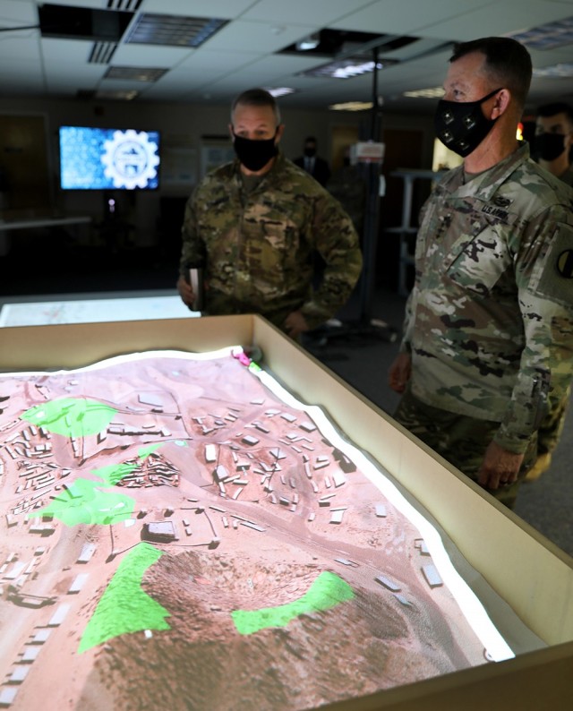 Combined Arms Center-Training Deputy Commanding General Brig. Gen. Charles Lombardo and Training and Doctrine Command Commanding General Gen. Paul E. Funk II check out the augmented reality sandbox at the Combined Arms Center-Training Innovation Facility during Funk’s visit to CAC-T Nov. 22, 2021. In addition to some of the synthetic training initiatives, Funk received updates on many of the projects the CAC-T subordinate organizations are working on during his visit. Photo by Tisha Swart-Entwistle, Combined Arms Center-Training Public Affairs.