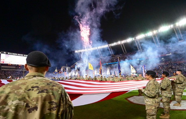 Fort Jackson trainees unfurl a 60 by 120 foot flag during the University of South Carolina’s Salute to Military Service football game halftime show Nov. 6. More than 300 trainees and Soldiers participated in the show by displaying all state and...