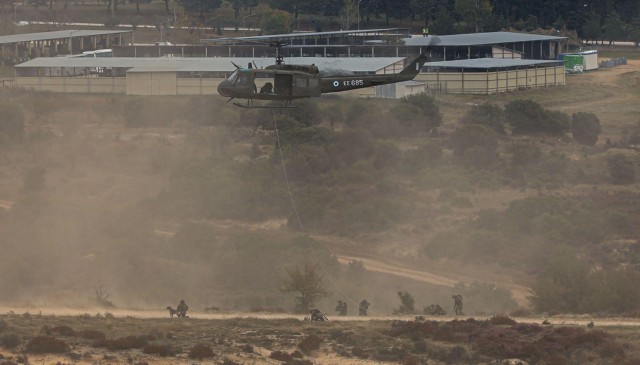 Hellenic Army soldiers rappel from a UH-1H Huey helicopter during a joint live-fire exercise for Olympic Cooperation 2021 at Petrochori Range, Triantafyllides Camp, Greece, Nov. 15, 2021. Olympic Cooperation is a joint training exercise that highlights the partnership between the U.S. and Greek forces. 