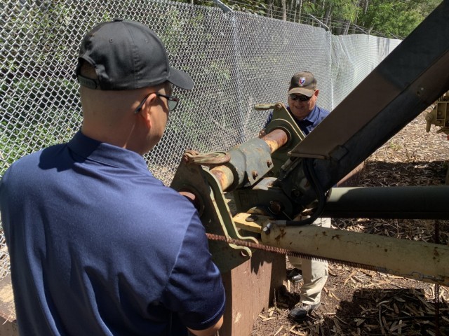 Two Logistics Assistance Representatives, known as LARs, from the United States Army Tank-automotive and Armaments Command remove spacer plates from a towing assembly on a heavy expanded mobility tactical truck wrecker during the Joint Pacific...
