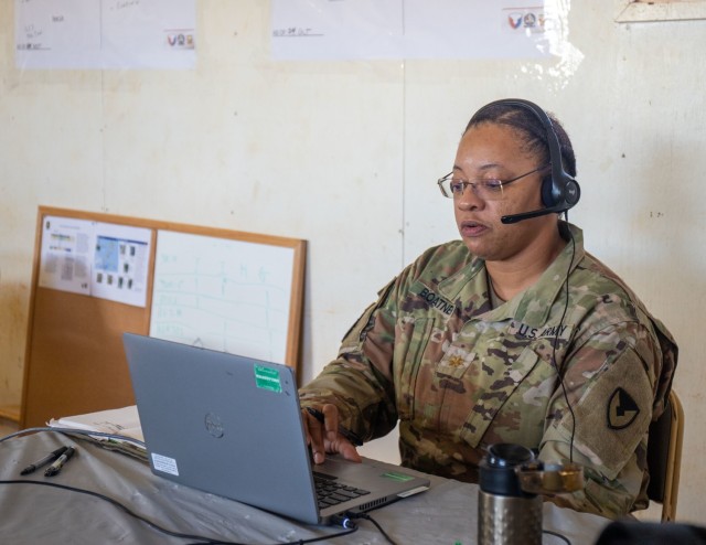 402nd Army Field Support Battalion-Hawaii Support Operations Officer Maj.Latrice Boatner connects with members of the 402nd AFSBn-Hawaii's Logistics Support Element Division to discuss the support needs of the 25th Division d infantry during the first training rotation of the Joint Multinational Pacific Readiness Center.  The DLSE provided upstream logistical support at the division level throughout the training.  (U.S. Army photo by Katie Nelson, 402nd Army Field Support Brigade)