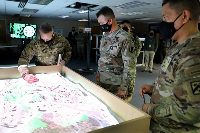 Combined Arms Center-Training Deputy Commanding General Brig. Gen. Charles Lombardo, Training and Doctrine Command Commanding General Gen. Paul E. Funk II and TRADOC Proponent Office-Synthetic Training Environment Director Col. Jim Pangelinan check out the augmented reality sandbox at the Combined Arms Center-Training Innovation Facility during Funk’s visit to CAC-T Nov. 22, 2021. In addition to some of the synthetic training initiatives, Funk received updates on many of the projects the CAC-T subordinate organizations are working on during his visit. Photo by Tisha Swart-Entwistle, Combined Arms Center-Training Public Affairs.