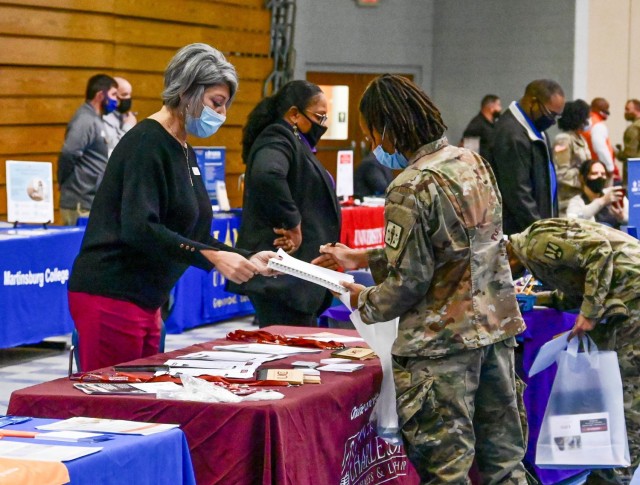 Maj. Kimberly Trice, assigned to 369th Adjutant Battalion, Soldier Support Institute, talks to a representative from the University of Charleston during the Education and Career Fair Nov. 16 at the Solomon Center. After a year of COVID-19 restrictions, the joint fair returned to Fort Jackson with 40 education institutes and 45 employers.