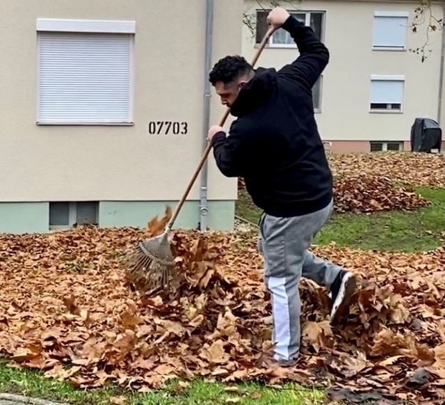 Andy Macias, an Army spouse and Hainerberg housing area resident spent the morning raking leave with his wife, Sgt. Martha Macias.