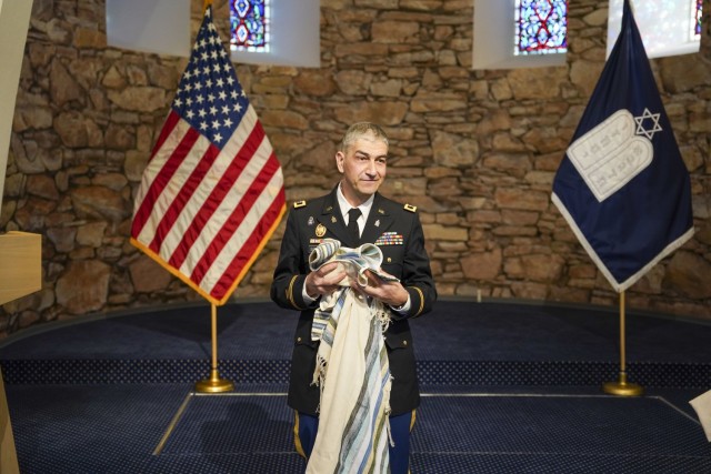 Chaplain (Col.) Henry Soussan, U.S. Army Garrison Bavaria Deputy Garrison Chaplain, holds a tallit he received as a gift after his promotion ceremony at the Tower Barracks Chapel, Nov. 23, 2021. (U.S. Army photo by Julian Temblador / USAG Bavaria)