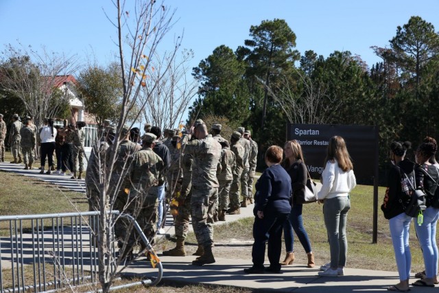 Soldiers assigned to the 3rd Infantry Division and Family members wait in line to go into the Spartan Dining Facility on Fort Stewart, Georgia, Nov. 24, 2021. Serving the Thanksgiving luncheon is a time-honored tradition for leaders to show...
