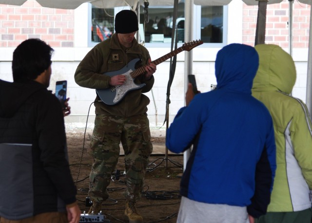 Spc. Patrick Haley, a guitarist with the 399th Army Band’s Rough Riders rock band, performs for Afghan evacuees and the Soldiers providing assistance to them Nov. 13 at Camp Atterbury, Indiana, in support of Operation Allies Welcome. The Rough...