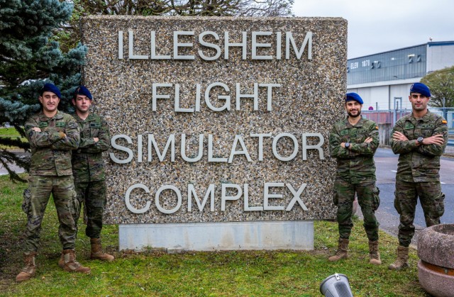 From left: Capt. Pedro Francisco Rodriguez Barragan, Warrant Officer 1 Julian Sevillano Mendez, Capt. Sergio Fernandez Anguela and Capt. Enrique Muńoz Manjón, CH-47 Chinook helicopter pilots, 5th Transport Helicopter Battalion, Spanish Army Aviation Brigade, pause for a photo in front of the Illesheim Flight Simulator Complex, located at Storck Barracks in Illesheim, Germany, Nov. 17, 2021. Centrally placed, the complex provides training simulations for U.S., NATO and partner nations to train without having to travel to facilities in the United States. 