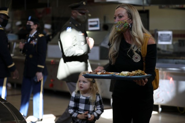 Dana Tillis, a spouse of a Soldier assigned to the 3rd Infantry Division, and her daughter, Taylor Tillis, gather food in the Spartan Dining Facility on Fort Stewart, Georgia, Nov. 24, 2021. Serving the Thanksgiving luncheon is a time-honored...