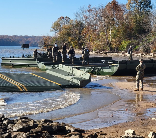 The 299th Multi-Role Bridge Company attaches a raft to a boat to prep for transportation on 18 Nov at Fort Belvoir. Photo by Maj. William C. Allred, 412th TEC PAO