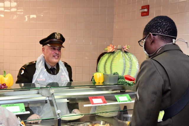 Lt. Col. Dennis Segui, Commander 187th Medical Battalion, serving Thanksgiving dinner at Rocco Dinning Facility.