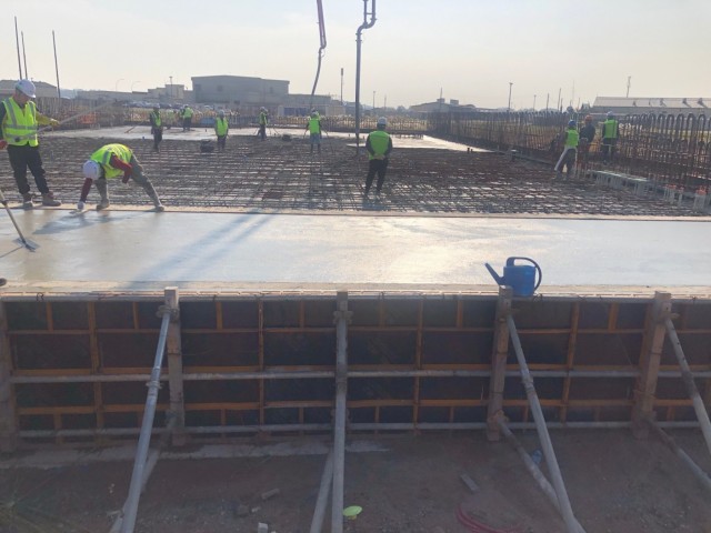 Contractors pour concrete for project HAS 4-6 (2019UMMA031), a host-nation funded project that will construct 18 new Hardened Aircraft Shelters, along with taxi lanes and hangar access aprons, Nov. 3.