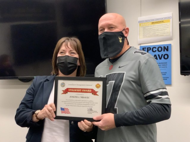 Joe Mravec receives his Stalwart Award from Garrison Manager Carrie Mead.