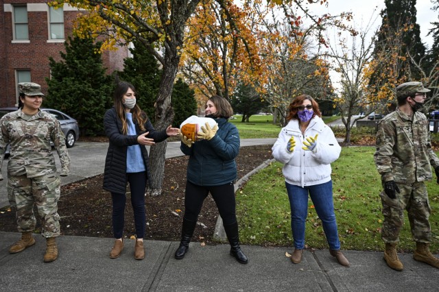 U.S. Air Force Airmen with Team McChord and volunteers from the local community help distribute turkeys during Operation Turkey Drop at Joint Base Lewis-McChord, Wash., Nov. 18, 2021. The Air Force Association McChord Field Chapter and the Pierce...