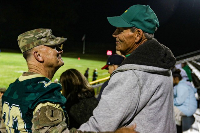 General Paul Funk II greets his former football coach for the first time in forty years before the final game of the season October 29. The Fort Knox Eagles honored Funk, commanding general, U.S. Army Training and Doctrine Command, and former Eagle football star, with a jersey retirement ceremony during halftime of the final game of the 2021 season. Funk's former coaches surprised him by attending the leader's homecoming ceremony and he attributed his initial leadership training to his mentors. Funk's wife, youngest son, and other family members and friends were in attendance for the momentous occasion. (U.S. Army photo by Staff Sgt. Nicholas Brown-Bell)