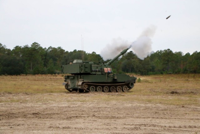 A modernized Paladin M109A7 howitzer, assigned to the “BattleKings Battalion,” 1st Battalion, 9th Field Artillery Regiment, 2nd Armor Brigade Combat Team, 3rd Infantry Division, fires a 155mm round during artillery Table VI section level...