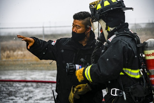 Rucci Hung-pyo, assistant chief of training for U.S. Army Garrison Humphreys Fire and Emergency Services, explains fire extinguishing techniques during a joint live fire training exercise at Humphreys Fire and Emergency Services training area Nov. 23, 2021.