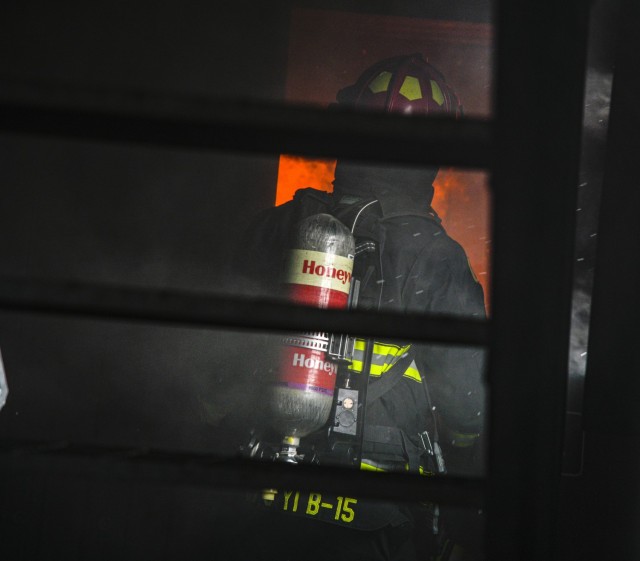 The fire captain guides firefighters through a class A burning room scenario during a combined live fire training exercise at Humphreys Fire and Emergency Services training area Nov. 23, 2021.