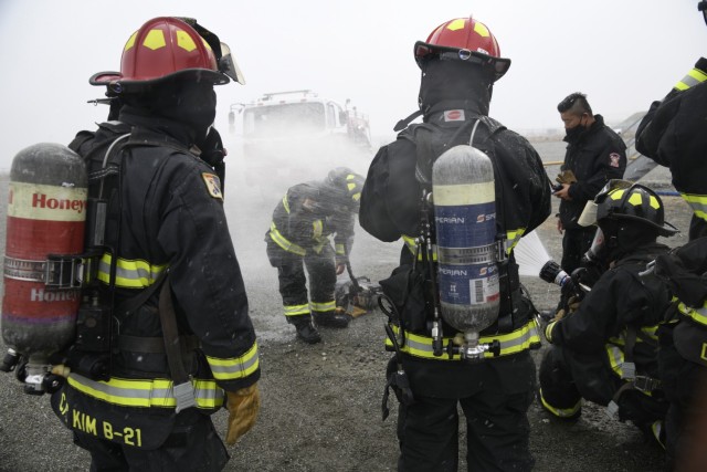 A firefighter gets doused with water after exiting the live fire training facility during a combined training exercise at Humphreys Fire and Emergency Services training area Nov. 23, 2021.