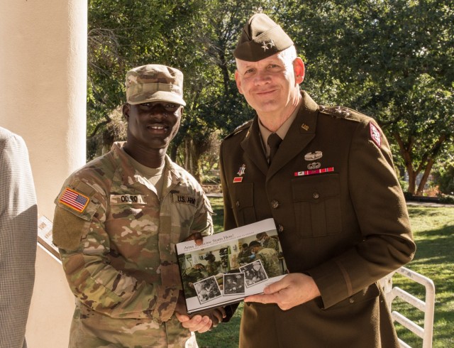 During the ceremony, personalized copies of the book were presented to the youngest Soldier, Pvt. Bright Odura, a 17-year-old 68W Combat Medic in training (pictured with Maj. Gen. Dennis P. LeMaster); James Murray, the Civilian employee with the most years in service; and Joseph Bray, the Civilian Aide to the Secretary of the Army, Texas (South).

MEDCoE Centennial Book Launch. Hosted by MG Dennis P. LeMaster, U.S. Army Medical Center of Excellence, Commanding General. AMEDD Museum-Vehicle Pergola, 3988 Stanley Road, Bldg. 1046, JBSA-Fort Sam Houston, Texas, 30NOV2021. (U.S. Army photo by Francis S. Trachta/Released)