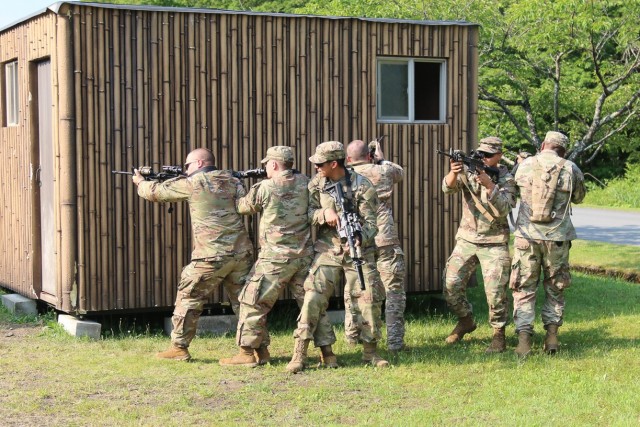 A group of Soldiers assigned to 1st Battalion, 28th Infantry Regiment, 3rd Infantry Division, split into smaller teams to capture an objective while practicing military operations in urban terrain on Camp Fuji, Japan, on June 10, 2021.