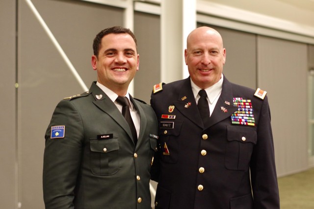Cpt. Albert Aslani of the Kosovo Security Force and retired Chief Warrant Officer 5 Matthew Schultz of the Iowa National Guard have worked together over the years and share a moment at a formal dinner at the Des Moines Area Community College in...