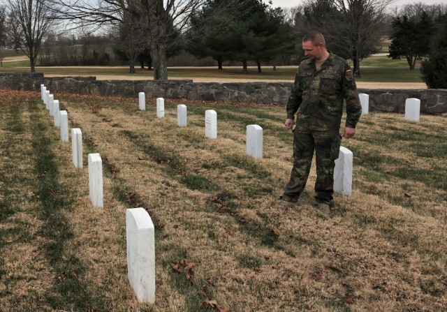 German Army liaison Sgt. Maj. Kay Wittmann stands, overlooking one of his countrymen’s graves in Fort Knox’s Main Post Cemetery at Fort Knox Dec. 1, 2021. In all, 17 German POWs are buried at Fort Knox.