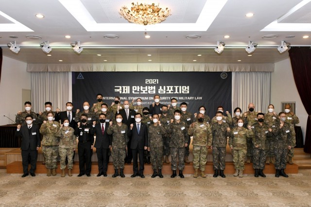 Soldiers and civilians from across Eighth Army’s Judge Advocate General's offices pose for a group photo with their Republic of Korea Army counterparts at the annual International Symposium on Security and Military Law held at the ROK Ministry of National Defense in Yongsan, Seoul, Nov. 24, 2021.