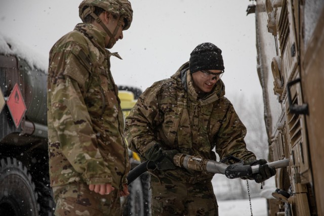 U.S. Army Pfc. Austin Daniele (right) with the 101st Brigade Support Battalion “Liberty,” 1st Armored Brigade Combat Team, 1st Infantry Division fuels a vehicle for Spc. Dillon Ranne with Headquarters and Headquarters Company, 1ABCT, 1ID, as they prepare for the field portion of Combined Resolve XVI at the Joint Multinational Readiness Center in Hohenfels, Germany, Dec. 2, 2021. Soldiers of HHC set up the tactical operations center where brigade leadership will direct multinational combined arms operations in a complex, multi-domain simulated battlespace. Combined Resolve XVI includes approximately 4,600 soldiers from Bulgaria, Georgia, Greece, Italy, Lithuania, Poland, Serbia, Slovenia, Ukraine, United Kingdom, and the United States. The operations are being conducted by integrated battalions with multinational units operating under a unified command and control element allowing the U.S., its allies and partners to experience invaluable training alongside each other. 