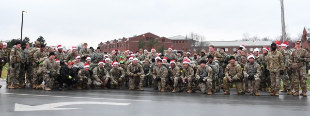 Senior noncommissioned officers across the 10th Mountain Division (LI) conduct a ruck march from the Noncommissioned Officer Academy to the Better Opportunities for Single Soldiers facility to deliver more than 100 toys for the annual Mountain of Toys program. Mountain of Toys is a Fort Drum Sergeants Major Association program developed 25 years ago to provide support to Soldiers and their families in need during the holiday season. (Photo by Mike Strasser, Fort Drum Garrison Public Affairs)