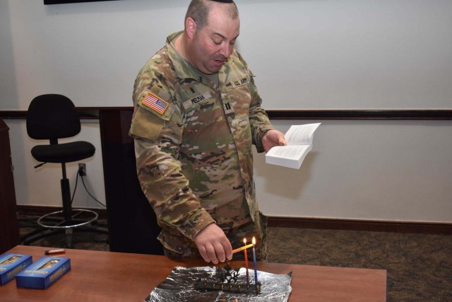 Rabbi (Capt.) Aaron Melman lights a candle during his presentation of the story of Chanukah and the Festival of Lights with his Chaplain Basic Officer Leader Course fellow students in class 21-003 on the USACHCS campus at Fort Jackson on Nov. 29....