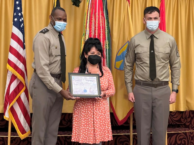 Kaiserslautern Elementary School Sure Start teacher Linda Rocha-Mendoza receives a certificate of appreciation from 21st Theater Sustainment Command Commanding General Maj. Gen. James Smith and Command Sgt. Maj. Sean Howard for volunteering during...