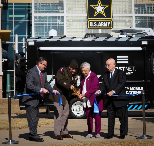 Richard Carrizzo, vice chair, FirstNet Government Authority Board of Directors; Lt. Gen. Donnie Walker, deputy commanding general of Army Materiel Command and senior commander of Redstone Arsenal, Alabama Governor Kay Ivey; and Wayne Hutchens, president of AT&T Alabama, cut a ribbon in honor of the FirstNet partnership, on the AMC Parade Field, Dec. 2. 