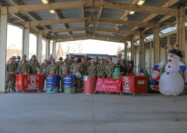 FORT KNOX, Ky. - V Corps Soldiers pose for a group photo with the local Red Cross after donating toys at Fort Knox, Kentucky, Dec. 2. Dozens of V Corps Soldiers attended a ruck march toy drive to boost holiday spirit and spread cheer to families and children in need in the local community. (U.S. Army photo by Pfc. Devin Klecan/released)