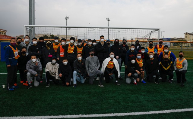 Korean Augmentation to the U.S. Army and American Soldiers from Headquarters and Headquarters Company, U.S. Army Garrison Humphreys break to take a group photo during a teambuilding soccer game at the soccer field Nov. 24, 2021.