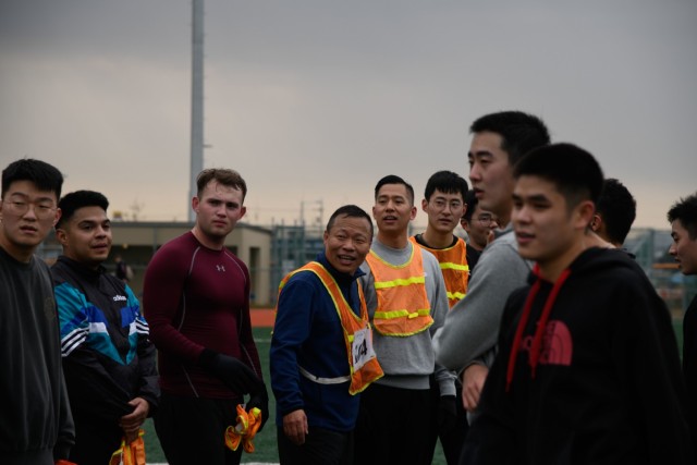 Korean Augmentation to the U.S. Army and American Soldiers from Headquarters and Headquarters Company, U.S. Army Garrison Humphreys line up for post-game handshakes after a teambuilding soccer game at the soccer field Nov. 24, 2021.