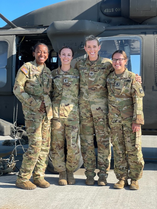 An all-female flight crew assigned to 16th Combat Aviation Brigade, poses at Joint Base Lewis-McChord, Wash., on Jul. 29, 2021.  Flight crews comprising of all women are uncommon due to the low number of females in Army aviation. (U.S. Army photo by Capt. Kyle Abraham, 16th Combat Aviation Brigade)