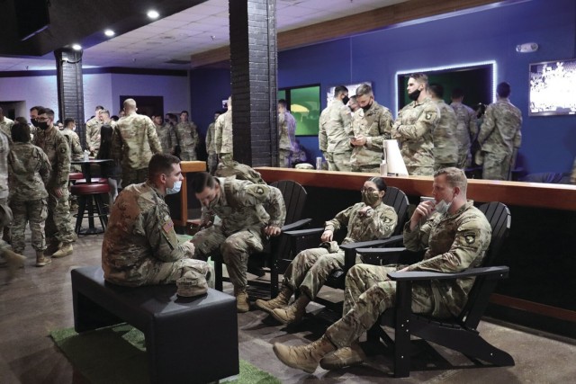 Screaming Eagle Soldiers relax while sitting in Adirondack chairs Nov. 24 at the Warrior Zone. Movable furniture such as these chairs is a new facet of the refreshed Warrior Zone. This furniture allows Soldiers to adjust their seating for watching any of the major sports channels offered at the Warrior Zone, gaming, eating or visiting with friends. (U.S. Army photo by Kaylee Dominik | Fort Campbell MWR)
