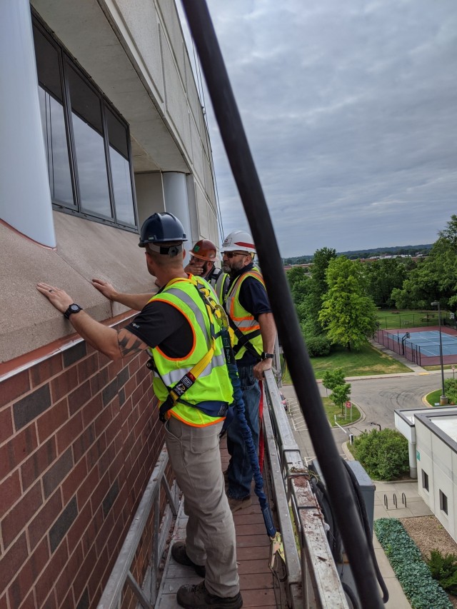 Todd Decosse (middle), U.S. Army Corps of Engineers, St. Paul District construction representative, and two contractors, work on the Minneapolis Veterans Affairs Medical Center in Minneapolis, June 23, 2020.