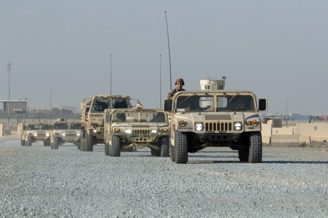 “Spears Ready” Soldiers of the Fort Bragg, N.C., based 3rd Expeditionary Sustainment Command convoy to an assembly area during a tactical action center displacement training exercise at Camp Arifjan, Kuwait, on Nov. 27, 2021. Expeditionary sustainment commands often displace their TACs forward in wartime to facilitate sustainment support on the front lines. The Soldiers have been deployed since August staffing the 1st Theater Sustainment Command’s operational command post.
