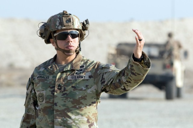 Master Sgt. Joseph A. Morales, a senior military police sergeant assigned to the Fort Bragg, N.C., based 3rd Expeditionary Sustainment Command directs traffic through the entry control point of an assembly area during a tactical action center displacement training exercise at Camp Arifjan, Kuwait, on Nov. 27, 2021. Expeditionary sustainment commands often displace their TACs forward in wartime to facilitate sustainment support on the front lines. Morales and fellow “Spears Ready” Soldiers have been deployed since August staffing the 1st Theater Sustainment Command’s operational command post.