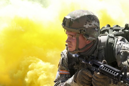 Army Spc. Caleb Romero, a California National Guardsman, scans his sector as smoke billows behind him during the mystery event of the California Guard’s Best Warrior Competition at Camp Roberts, Calif., March 31, 2021.