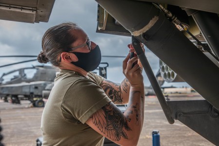 Soldiers of the 25th Combat Aviation Brigade perform routine maintenance on AH-64 Apache Helicopters at Wheeler Army Airfield, Hawaii, April 20, 2021. Maintainers identify, troubleshoot, and repair any issues the aircraft may be experiencing.