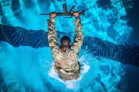 A soldier completes a swim test at Schofield Barracks, Hawaii, May 14, 2021, while practicing for an upcoming Jungle Operations Training Course.