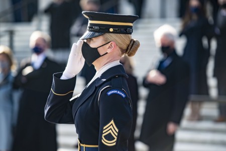 Army Sgt. 1st Class Chelsea Porterfield, the 38th Sergeant of the Guard — and first female — at the Tomb of the Unknown Soldier, renders honors during a wreath-laying ceremony at Arlington National Cemetery, Va., Jan. 20, 2021. 