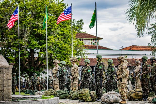 U.S. Army Soldiers assigned to 101st Airborne Division (Air Assault) and Brazilian army soldiers assigned to 5th Light Infantry Battalion stand in formation during the opening ceremony of Southern Vanguard 22 in Lorena Brazil, Dec. 6 2021. Southern Vanguard 22 was planned as a 10-day air assault operation and was the largest deployment of a U.S. Army unit to train with the Brazilian army forces in Brazil. (U.S Army photo by Pfc. Joshua Taeckens)
