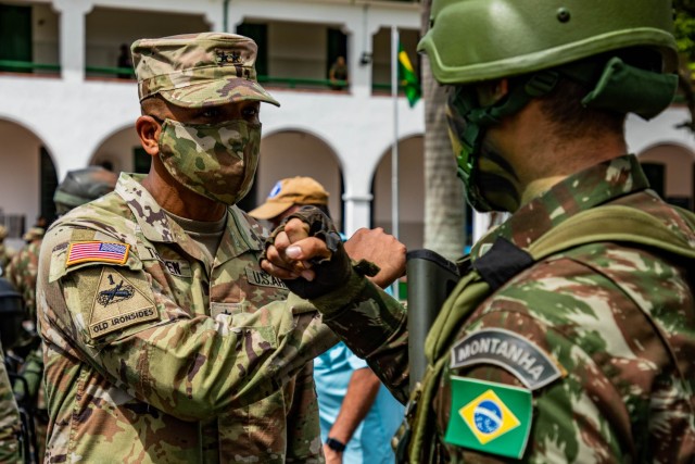U.S. Army South Commanding General, Gen. William Thigpen, greets a Brazilian army soldier during the opening ceremony of Southern Vanguard 22 at the 5th Light Infantry in Lorena, Brazil, Dec. 6, 2021. Battalion Southern Vanguard 22 was planned as a 10-day air assault operation and was the largest deployment of a U.S. Army unit to train with the Brazilian army forces in Brazil. (U.S Army photo by Pfc. Joshua Taeckens)
