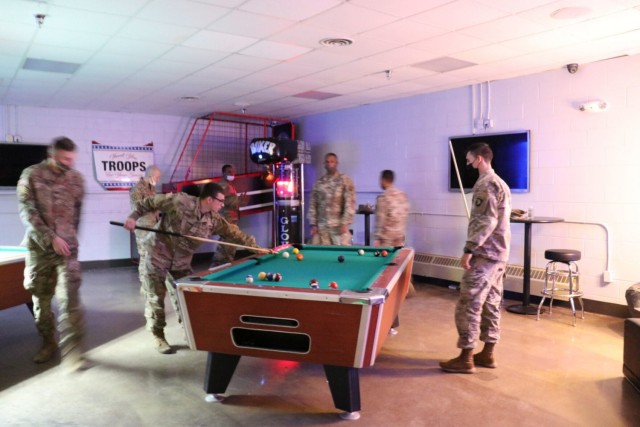 Screaming Eagle Soldiers play a game of pool together Nov. 24 at the Warrior Zone. In addition to the pool table, the recently refreshed space is still home to some of Soldier favorite past times such as air hockey, ping pong, darts and the boxing area. (U.S. Army photo by Kaylee Dominik | Fort Campbell MWR)